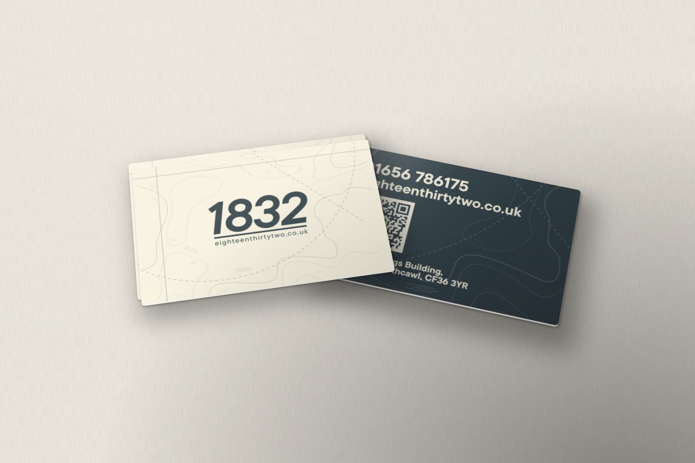 Mockup: 1832 business cards, the logo on the front and the phone number, web address, QR code and address on the back.