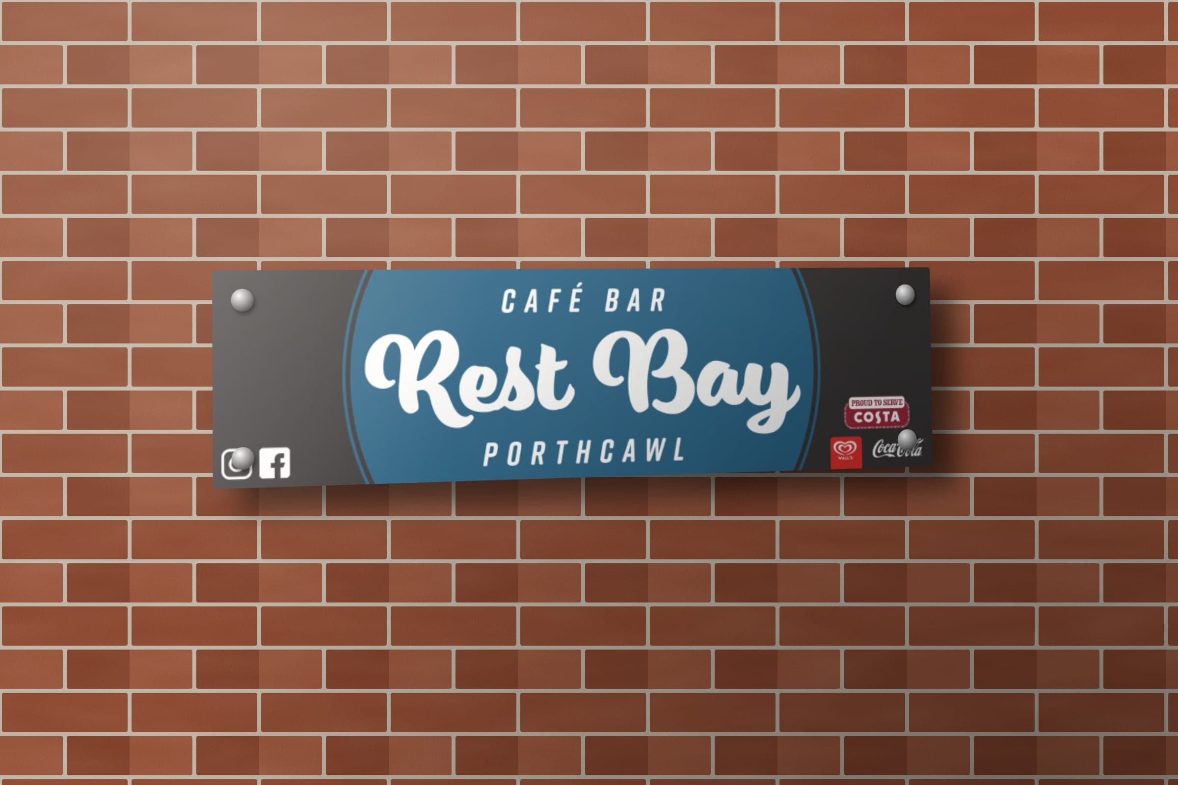 Mockup: the beach kiosk head board with the Rest Bay Café Bar logo, social icons and Costa, Wall's and Coca-Cola marks.