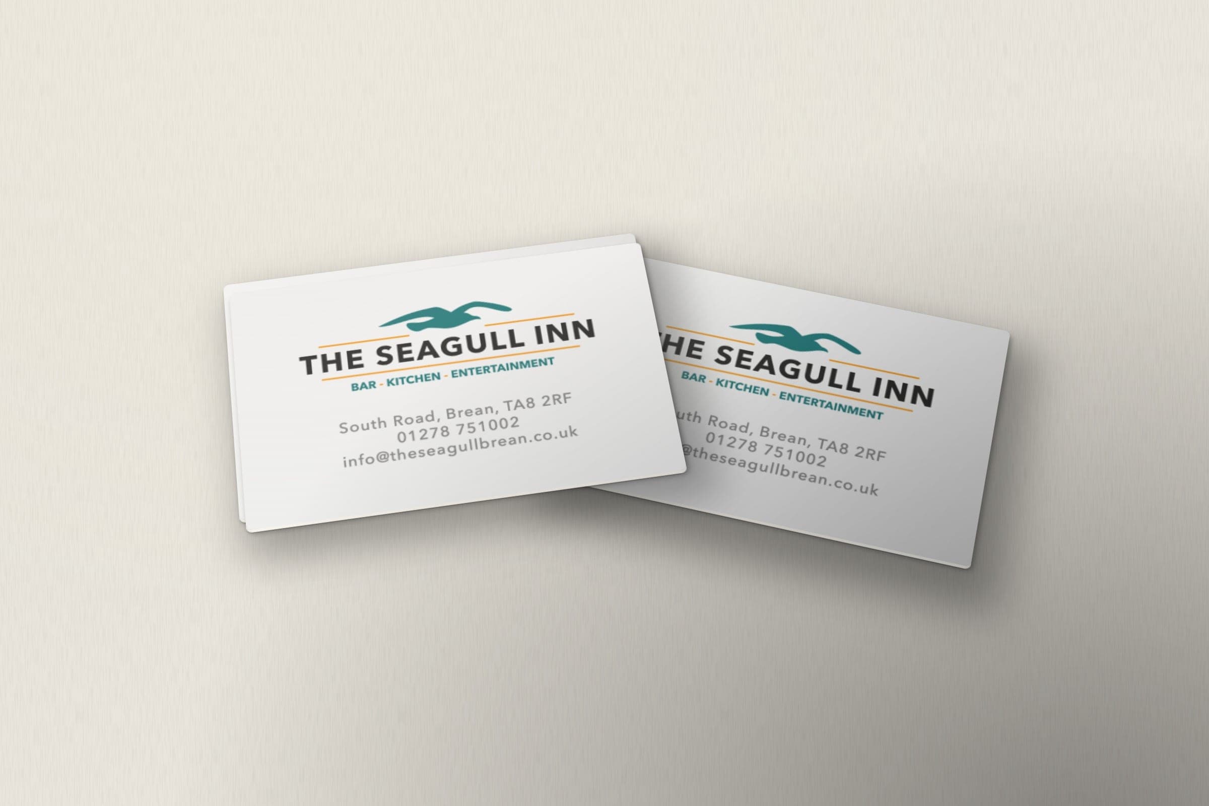 Mockup: The Seagull Inn cards with the logo, address, phone number and email.